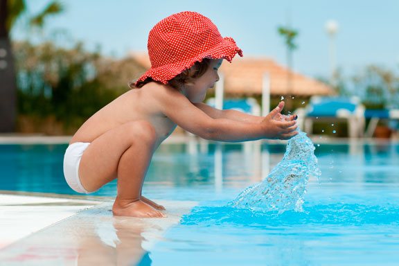 kid playing in pool