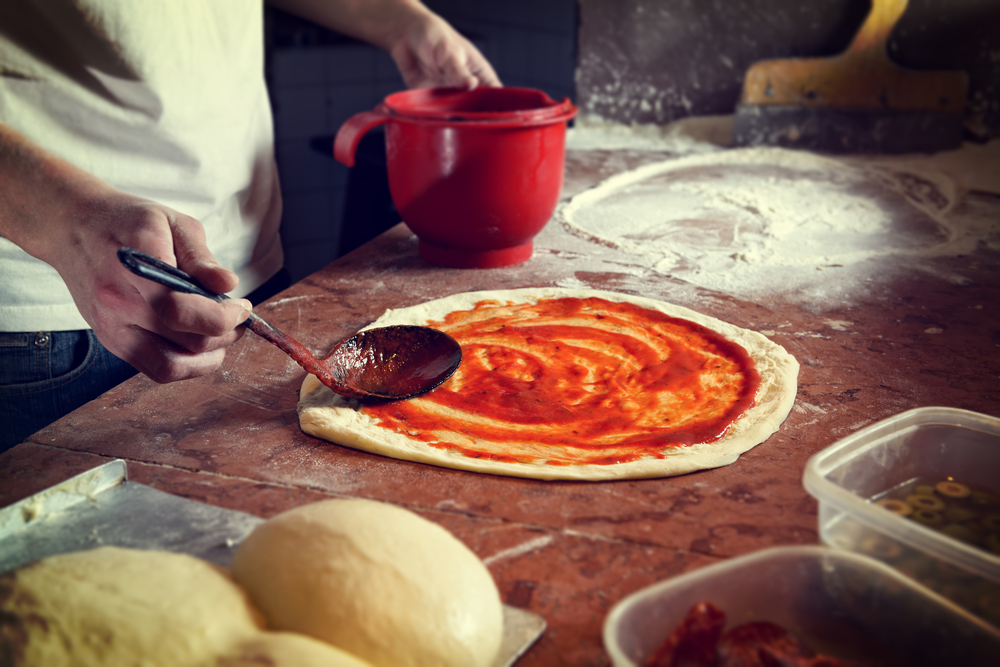 Fresh original Italian raw pizza, preparation in traditional style