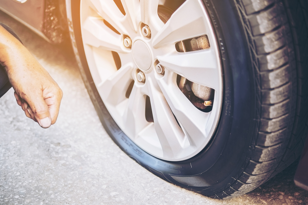 Technician is repairing car flat tire