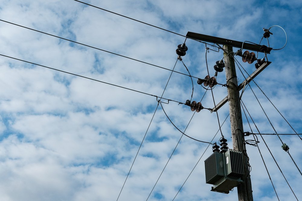 Detailed view of a high power electrical cabling system seen atop a utility pole