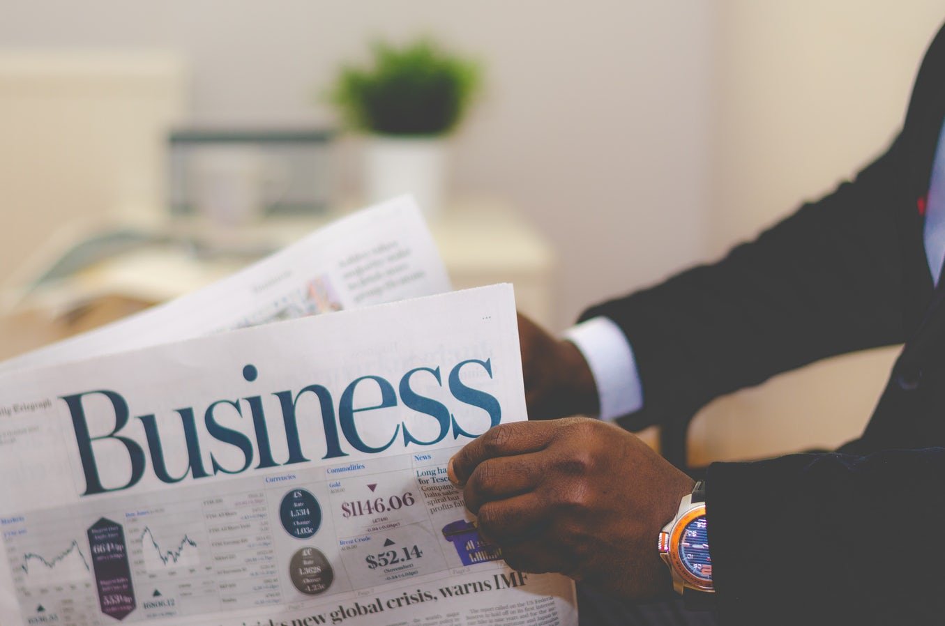 Black business man reading the business section