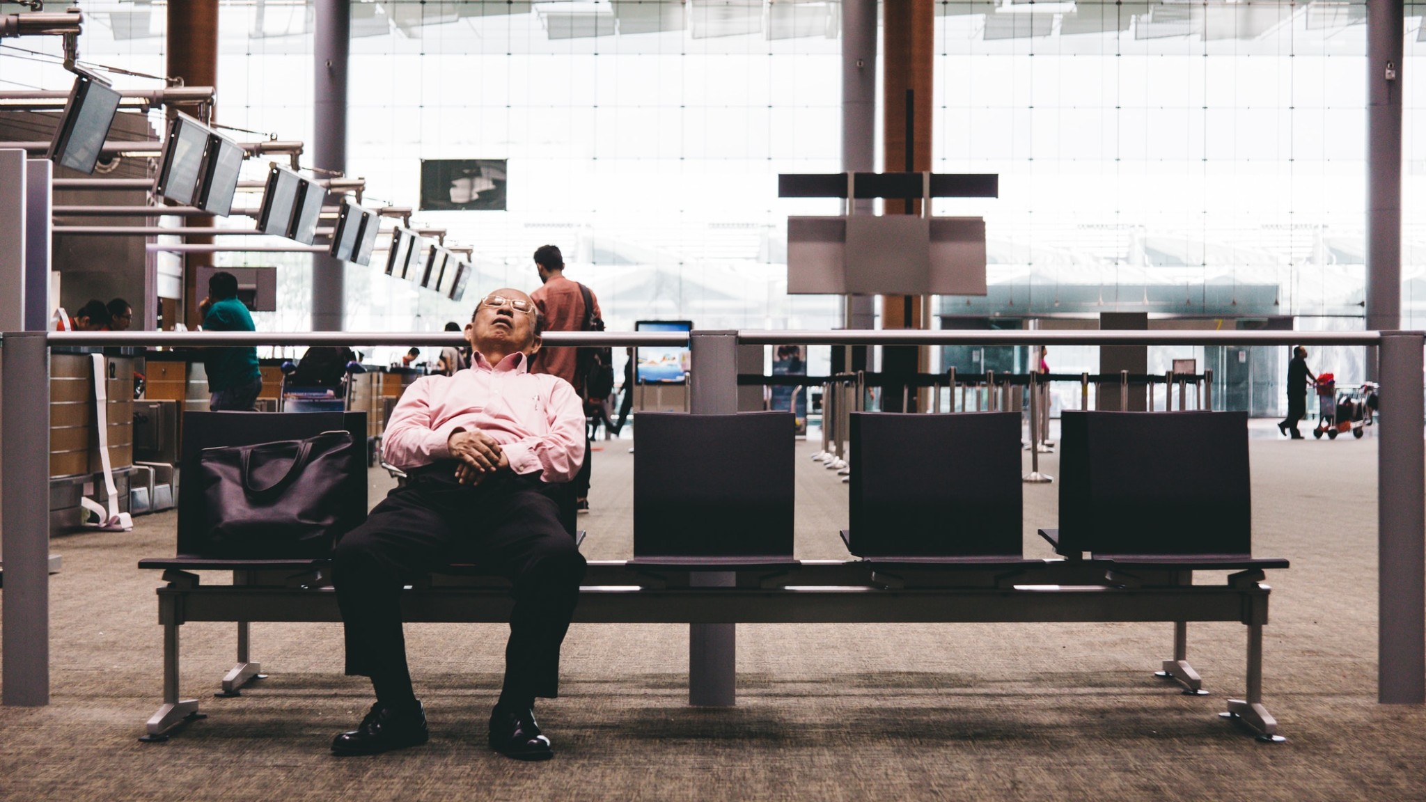 man asleep in airport terminal