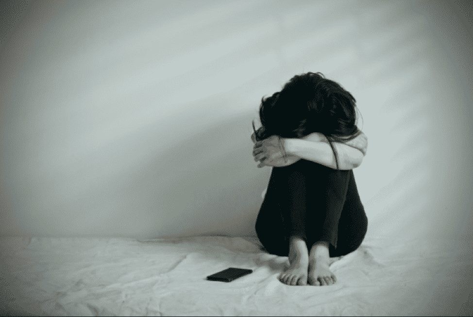woman sitting in the fetal position