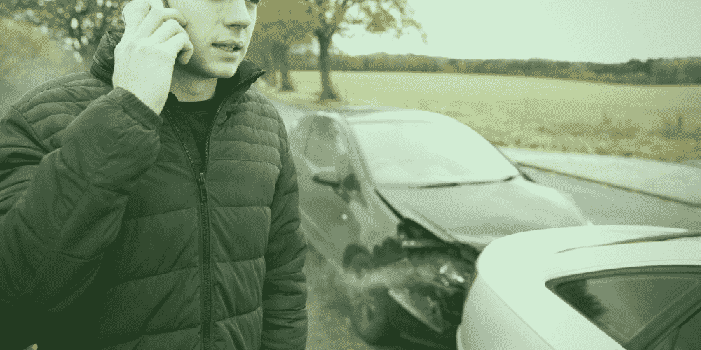 young lad making phone call after car accident