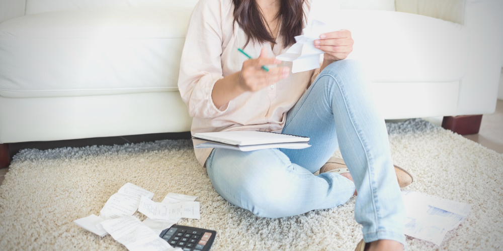 A woman working on math involving receipts