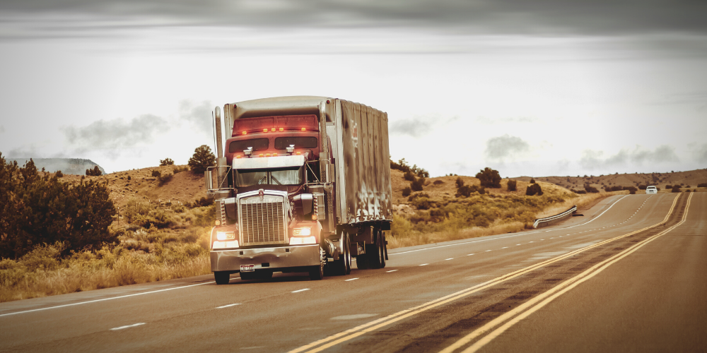 Semi truck driving on empty highway